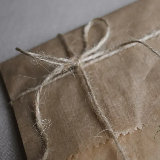 Sealed parcels tied with ribbon, inventoried before a white-glove courier run