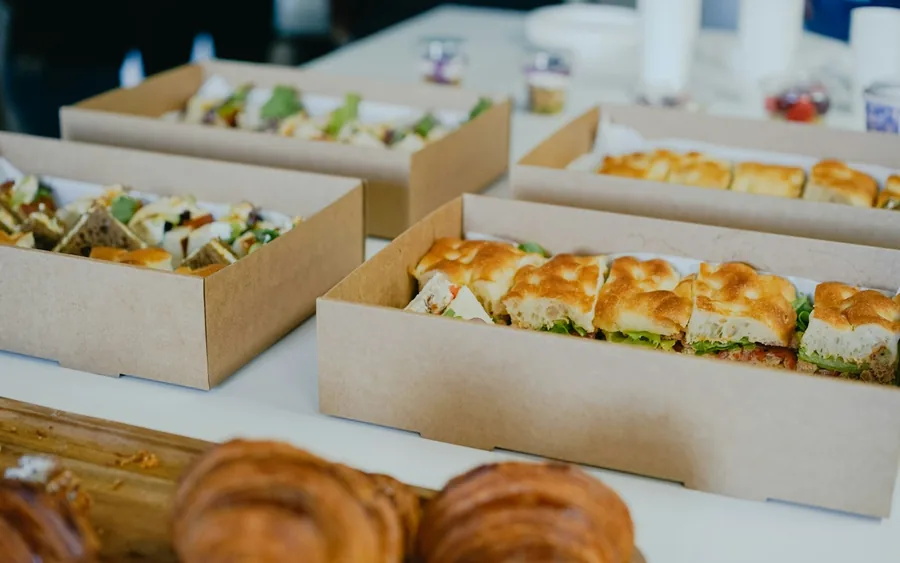 Catering trays boxed and ready to leave the kitchen for an office delivery